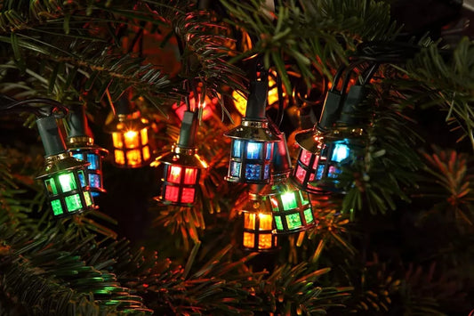 close up shot of NOMA victorian lantern LED lights hanging on a Christmas tree