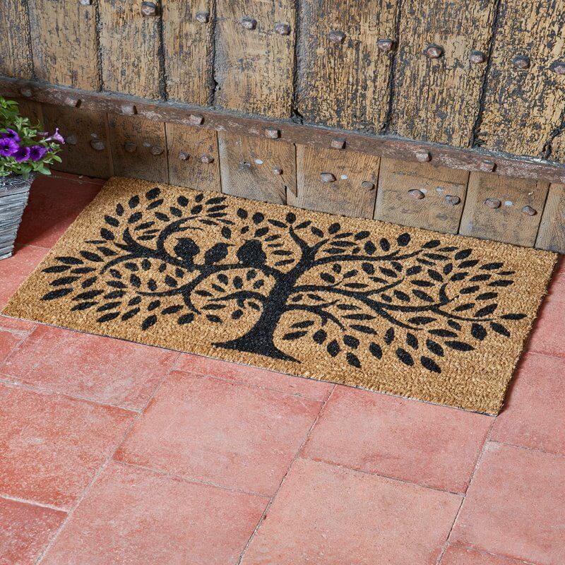Dickie Birds tree coir doormat with black tree and bird silhouette on a tiled step