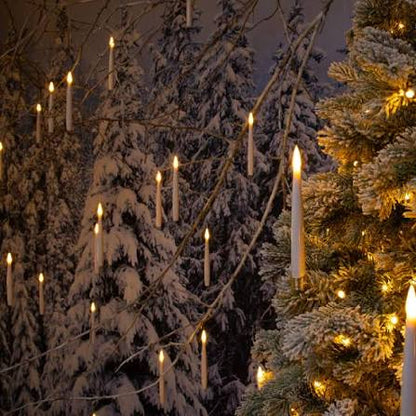 LED candles with warm flicker hanging among snowy pine branches near a Christmas tree