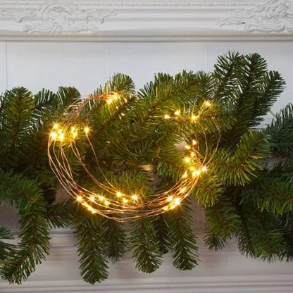 NOMA warm white copper wire horses tail lights displayed on a fir Christmas garland