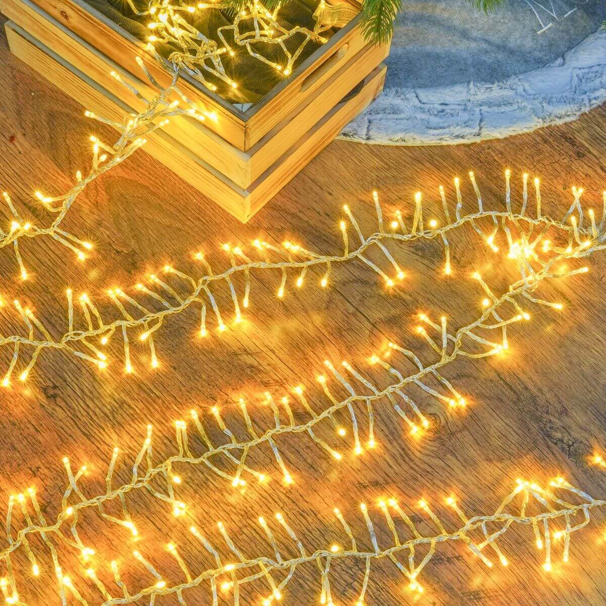 String of warm white cluster lights laid against a wooden floor